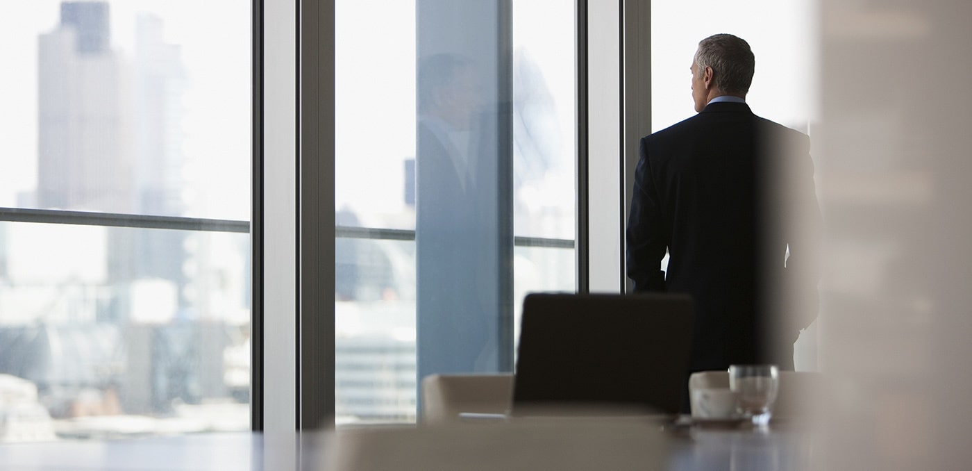 Businessman looking out conference room window